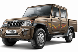 Mahindra Bolero Camper 4WD  A brown Mahindra Bolero Camper 4WD with off-road driving capabilities and strong suspension